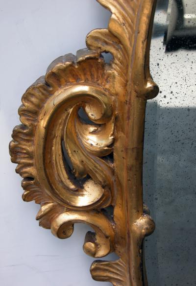 An Elegantly Carved French Louis XV Rococo Giltwood Oval Mirror