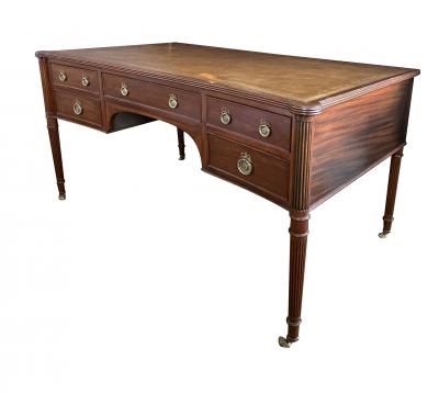 An English George III style mahogany concave writing desk
