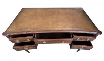 An English George III style mahogany concave writing desk