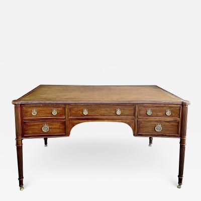 An English George III style mahogany concave writing desk