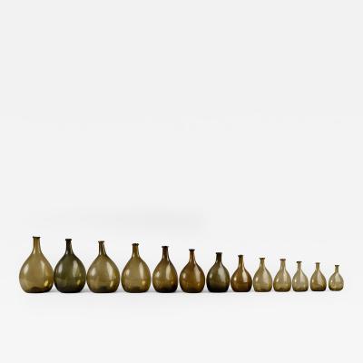 An Exceptional Set of 13 Graduated Blown Chestnut Bottles