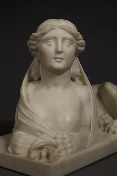 An Imposing Carved Statuary Marble Sculpture Of A Reclining Veiled Female Sphinx