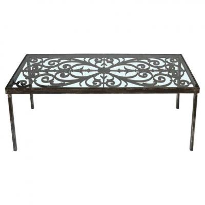 An Iron Cocktail Table with Glass Top