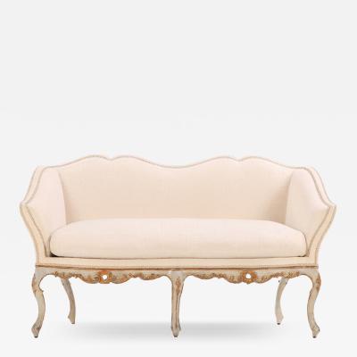 An Italian painted and carved settee 18th C in recent fabric 