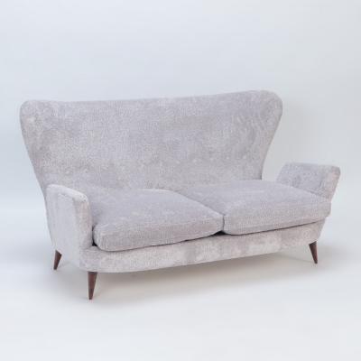 An Italian vintage wingback drop arm upholstered settee 