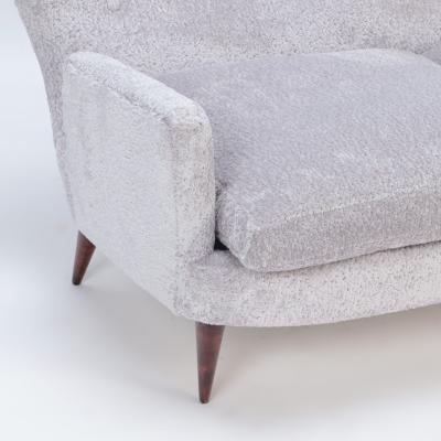 An Italian vintage wingback drop arm upholstered settee 