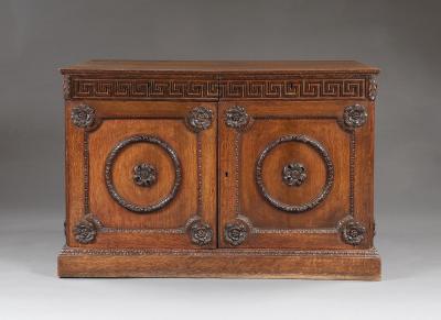 An Oak Two Door Folio Cabinet With Carved Kentian Detailing