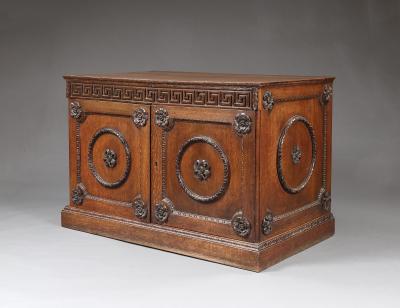 An Oak Two Door Folio Cabinet With Carved Kentian Detailing
