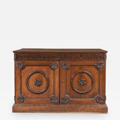 An Oak Two Door Folio Cabinet With Carved Kentian Detailing