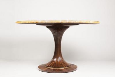 An Oval Pedestal Table by ILIAD Design