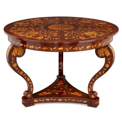 An antique French circular marquetry table with floral inlay