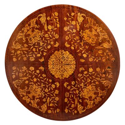 An antique French circular marquetry table with floral inlay