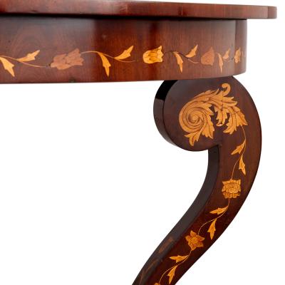 An antique French circular marquetry table with floral inlay