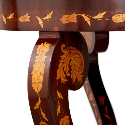 An antique French circular marquetry table with floral inlay