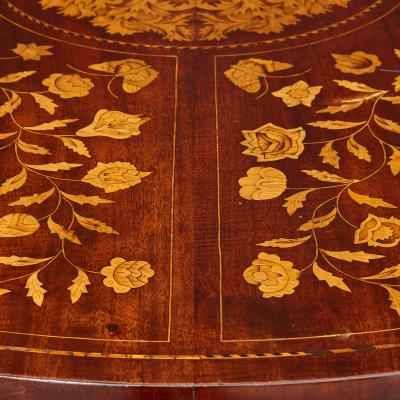 An antique French circular marquetry table with floral inlay