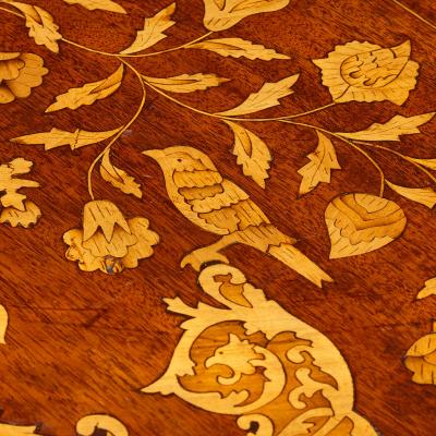 An antique French circular marquetry table with floral inlay