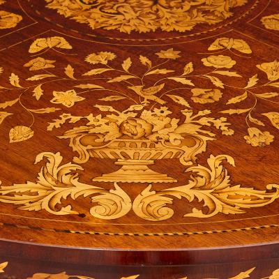 An antique French circular marquetry table with floral inlay