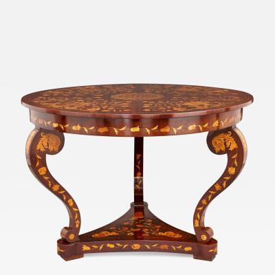 An antique French circular marquetry table with floral inlay