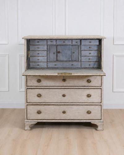 An antique Swedish bureau in antique white