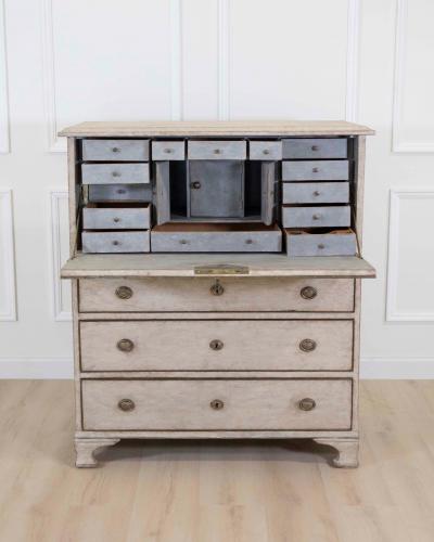 An antique Swedish bureau in antique white