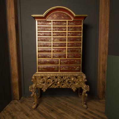 An antique chinoiserie lacquer storage cabinet on carved giltwood stand