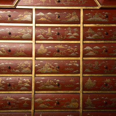 An antique chinoiserie lacquer storage cabinet on carved giltwood stand