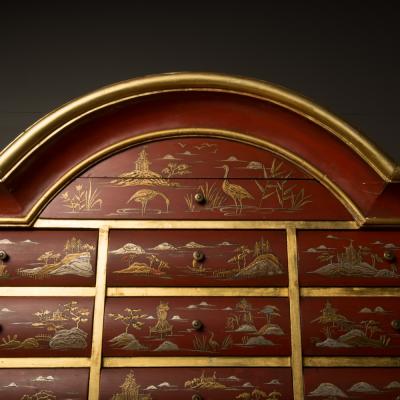 An antique chinoiserie lacquer storage cabinet on carved giltwood stand