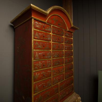 An antique chinoiserie lacquer storage cabinet on carved giltwood stand