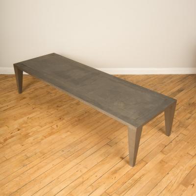 An artist designed metal clad silver color coffee table with holes in top