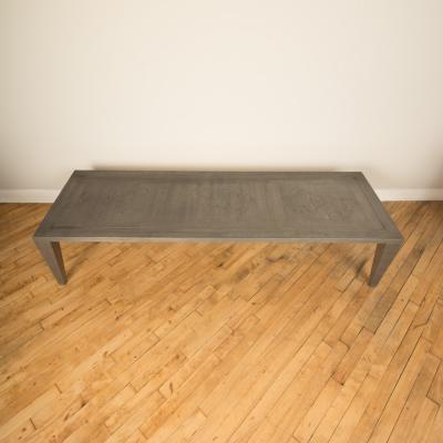 An artist designed metal clad silver color coffee table with holes in top