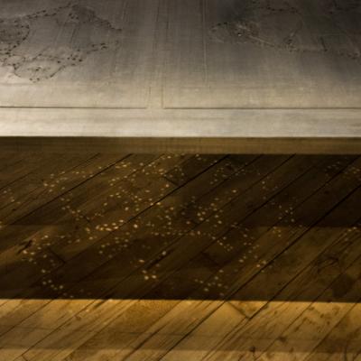 An artist designed metal clad silver color coffee table with holes in top