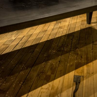 An artist designed metal clad silver color coffee table with holes in top