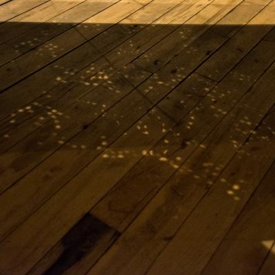 An artist designed metal clad silver color coffee table with holes in top