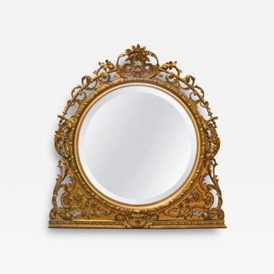 An attractive Continental round carved gilt wood mantel mirror