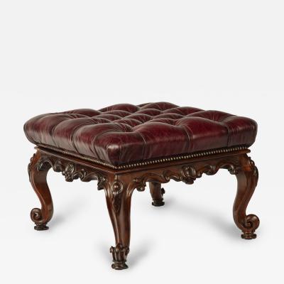 An early Victorian leather upholstered rosewood stool