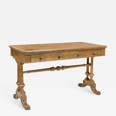 An early Victorian rosewood writing table by Holland Sons