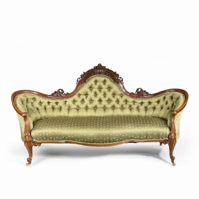 An elaborate Victorian shaped walnut sofa
