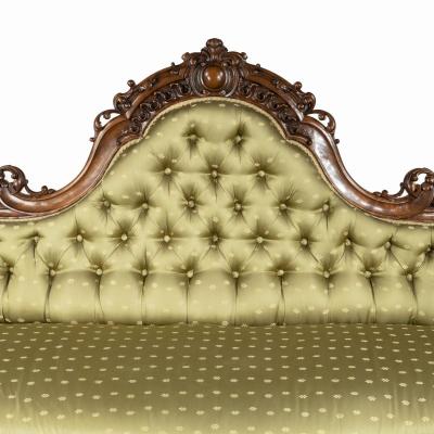 An elaborate Victorian shaped walnut sofa