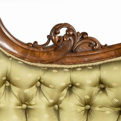An elaborate Victorian shaped walnut sofa