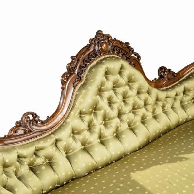 An elaborate Victorian shaped walnut sofa