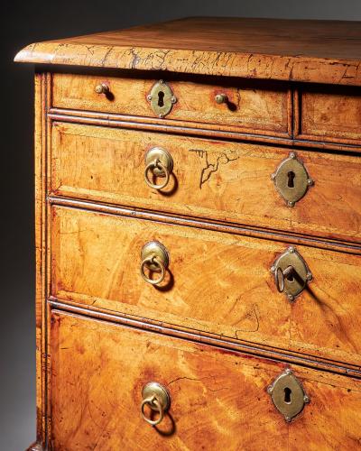 An extremely rare George I walnut chest of small proportions on ball and bracket