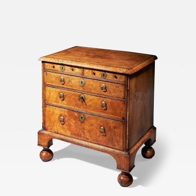 An extremely rare George I walnut chest of small proportions on ball and bracket