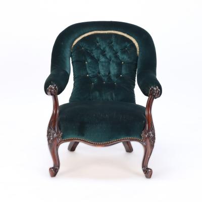 An imposing velvet upholstered library armchair with continuous arm 19th C 
