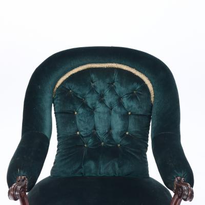 An imposing velvet upholstered library armchair with continuous arm 19th C 