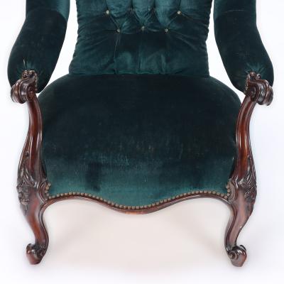 An imposing velvet upholstered library armchair with continuous arm 19th C 
