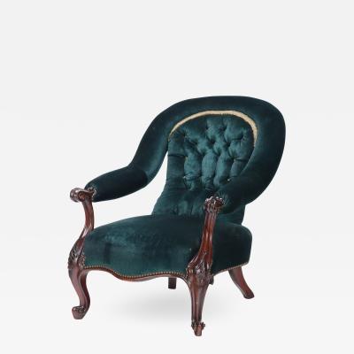 An imposing velvet upholstered library armchair with continuous arm 19th C 