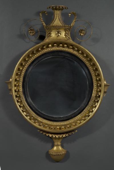 An unusual Regency giltwood convex mirror