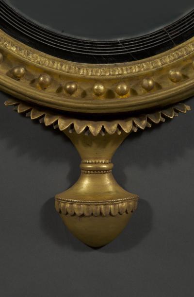 An unusual Regency giltwood convex mirror