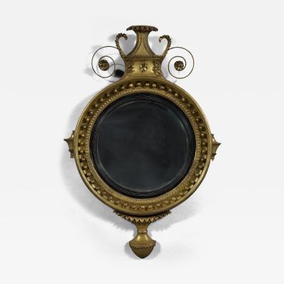 An unusual Regency giltwood convex mirror