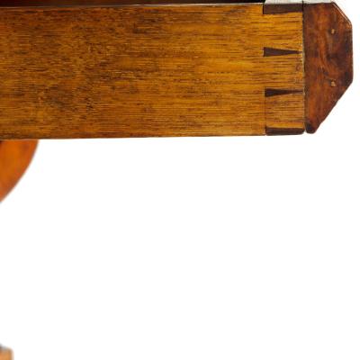 An unusual William IV amboyna and oak four drawer library table by Simpson